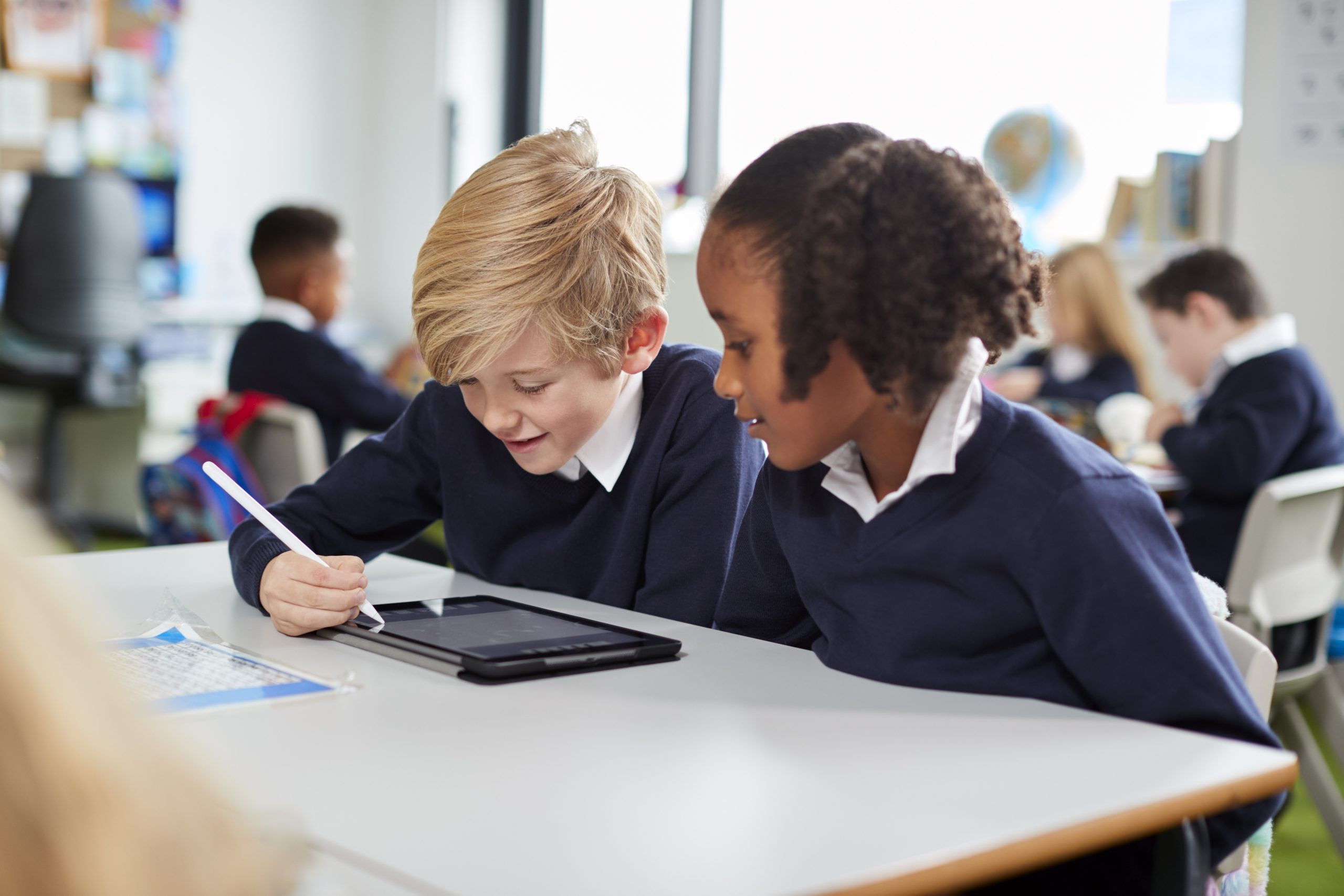 Two children on the tablet in school