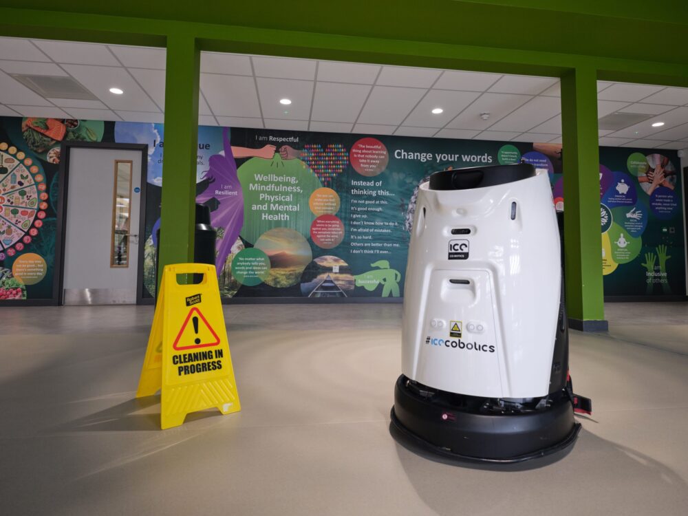 Cobot next to wet floor sign