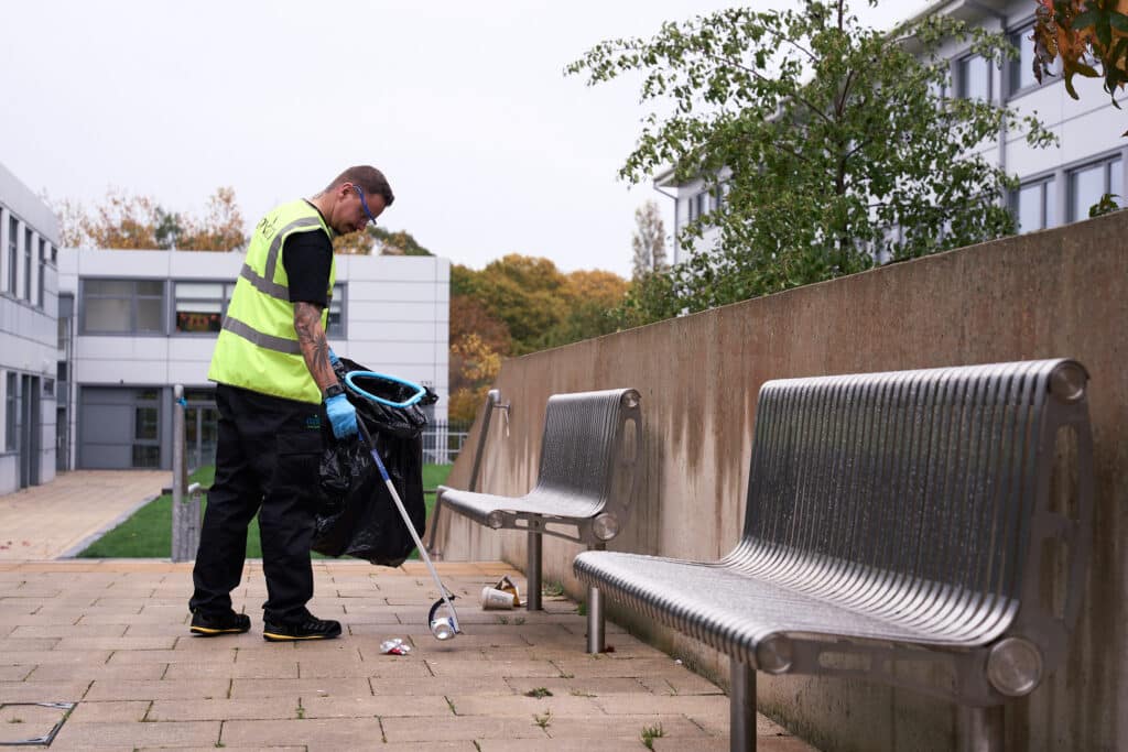 Image of person litter picking outside to represent